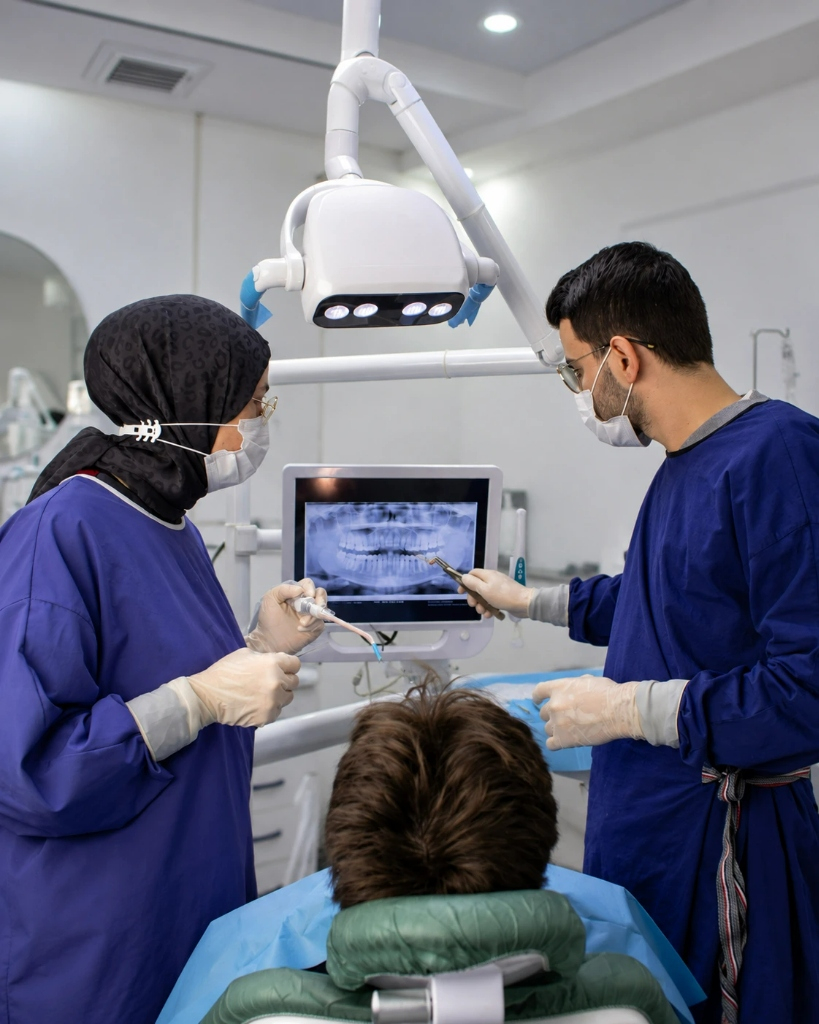 Dental specialists reviewing X-ray with patient at Ilaj Dental Care